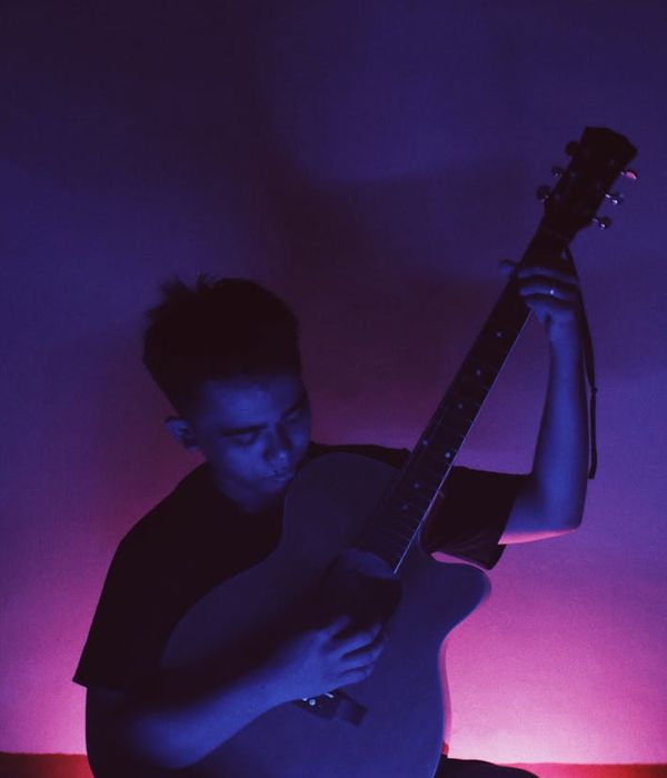 Person practicing gentle eye movements in a dark room